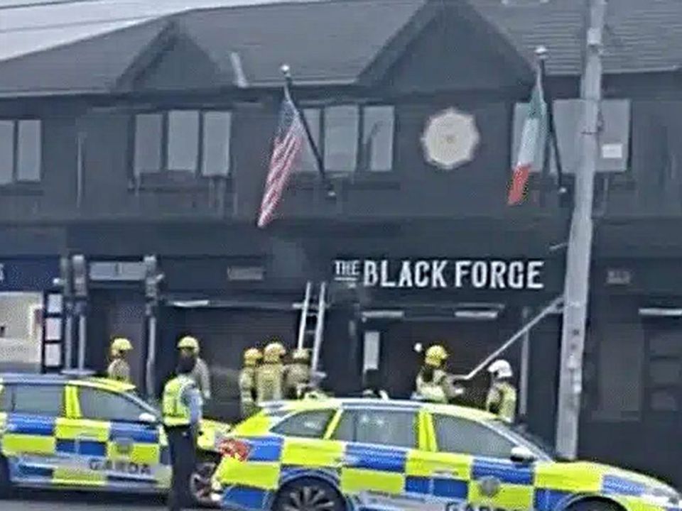 Firefighters at the scene after arson attack on Conor mcGregor's Black Forge pub